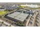 An aerial view of tennis and pickleball courts in a community with lush landscaping and surrounding residential area at 17347 W Chama Dr, Surprise, AZ 85387