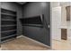 Large walk-in closet with custom shelving and clothing rods at 17347 W Chama Dr, Surprise, AZ 85387