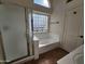 Bathroom featuring a shower, bathtub, and a frosted window providing natural light at 1771 E Erie St, Gilbert, AZ 85295