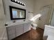 Bathroom with double sinks, decorative mirror, and separate toilet and shower area at 1771 E Erie St, Gilbert, AZ 85295