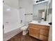 Bathroom featuring a tub, shower, wood vanity, and a well-lit mirror above the sink at 1771 E Erie St, Gilbert, AZ 85295