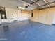 Spacious garage featuring a stylish epoxy floor and ample storage cabinets along the back wall at 1771 E Erie St, Gilbert, AZ 85295