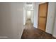 Clean hallway with tile flooring, neutral paint, and a built-in storage cabinet at 1771 E Erie St, Gilbert, AZ 85295