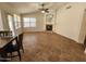 Open living room with a cozy fireplace and large windows, offering abundant natural light at 1771 E Erie St, Gilbert, AZ 85295