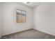 Bedroom with carpeted floor and window; a simple space to relax and unwind at 20570 S 216Th Pl, Queen Creek, AZ 85142