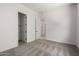 Spacious bedroom with carpeted floor and multiple doors showcasing an open layout at 20570 S 216Th Pl, Queen Creek, AZ 85142