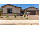 Charming single-story home with desert landscaping, a brick driveway, and a two-car garage at 20570 S 216Th Pl, Queen Creek, AZ 85142