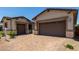 Charming single-story home with a brick-paved driveway and two-car garage at 20570 S 216Th Pl, Queen Creek, AZ 85142