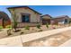 Well-manicured front yard featuring desert landscaping and a charming façade at 20570 S 216Th Pl, Queen Creek, AZ 85142