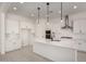 Bright, modern kitchen featuring white cabinets, an island, and stainless steel appliances at 20570 S 216Th Pl, Queen Creek, AZ 85142