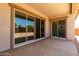 Covered patio with sliding glass doors overlooking the backyard at 20570 S 216Th Pl, Queen Creek, AZ 85142