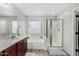 This bathroom features a soaking tub, glass enclosed shower, and double sink vanity at 25589 W Pleasant Ln, Buckeye, AZ 85326