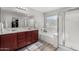 This bathroom features a double sink vanity, soaking tub, and glass-enclosed shower at 25589 W Pleasant Ln, Buckeye, AZ 85326