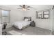 Cozy bedroom features natural light from two windows, carpet flooring, a ceiling fan, and neutral walls at 25589 W Pleasant Ln, Buckeye, AZ 85326