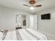 Bedroom featuring a ceiling fan, mirrored closet doors, and a wall-mounted television at 25589 W Pleasant Ln, Buckeye, AZ 85326
