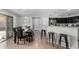 Open-concept dining area with bar seating, stylish lighting, and easy access to the kitchen at 25589 W Pleasant Ln, Buckeye, AZ 85326
