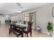 An inviting dining room boasts a dark wood table, modern light fixture and sliding glass doors at 25589 W Pleasant Ln, Buckeye, AZ 85326