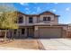 Charming two-story home with a well-manicured front yard and neutral-toned facade at 25589 W Pleasant Ln, Buckeye, AZ 85326