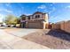 Two-story home with a spacious driveway and xeriscaped front yard for easy maintenance at 25589 W Pleasant Ln, Buckeye, AZ 85326