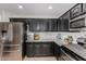 This kitchen boasts dark cabinets, stainless steel appliances and granite countertops at 25589 W Pleasant Ln, Buckeye, AZ 85326