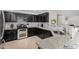 The kitchen features granite countertops, stainless steel appliances, dark cabinetry and a tile backsplash at 25589 W Pleasant Ln, Buckeye, AZ 85326
