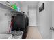 Functional laundry room equipped with a washer, dryer, shelving, and storage for laundry supplies at 25589 W Pleasant Ln, Buckeye, AZ 85326