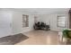 Bright living area with a comfortable office setup, tile floors, and natural lighting at 25589 W Pleasant Ln, Buckeye, AZ 85326