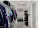Organized walk-in closet with shelves and hanging rods, providing ample storage space for clothing and accessories at 25589 W Pleasant Ln, Buckeye, AZ 85326
