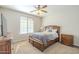 Comfortable bedroom featuring a wood bed frame and a ceiling fan for optimal air circulation at 25742 N 103Rd Dr, Peoria, AZ 85383