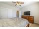 Relaxing bedroom boasts a cozy gray comforter, carpet, and a spacious closet for storage solutions at 25742 N 103Rd Dr, Peoria, AZ 85383