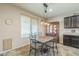 Bright dining area with a tile table, a hutch, and a pendant light at 25742 N 103Rd Dr, Peoria, AZ 85383