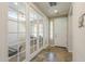 Welcoming foyer with tile flooring, natural light, and glass-paneled doors leading to an office space at 25742 N 103Rd Dr, Peoria, AZ 85383