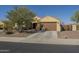 Charming single-story home with desert landscaping, a spacious driveway, and a two-car garage at 25742 N 103Rd Dr, Peoria, AZ 85383