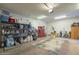 Organized garage featuring ample storage shelves, tools, and workspace, providing practical solutions for homeowners at 25742 N 103Rd Dr, Peoria, AZ 85383
