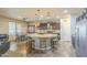 Kitchen with a large island, pendant lighting, and a dining area with a hutch at 25742 N 103Rd Dr, Peoria, AZ 85383