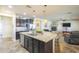 Open-concept kitchen with a large island, granite countertops, and modern appliances at 25742 N 103Rd Dr, Peoria, AZ 85383