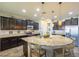 Spacious kitchen with island seating, stainless steel appliances, and granite countertops at 25742 N 103Rd Dr, Peoria, AZ 85383