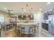 Kitchen with a large island, pendant lights, stainless steel appliances, and a hutch at 25742 N 103Rd Dr, Peoria, AZ 85383