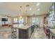 Open-concept living space with a kitchen island and a comfortable living room at 25742 N 103Rd Dr, Peoria, AZ 85383