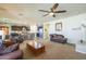 Open-concept living room that flows into the kitchen, with neutral walls and comfortable seating at 25742 N 103Rd Dr, Peoria, AZ 85383