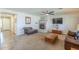 Inviting living room with a cozy fireplace, neutral-colored walls, and a ceiling fan at 25742 N 103Rd Dr, Peoria, AZ 85383