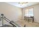 Cozy office space with a desk, a ceiling fan, and neutral-toned walls at 25742 N 103Rd Dr, Peoria, AZ 85383