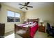 This bedroom features a ceiling fan, a large window, carpet, and a comfortable bed, creating a cozy and inviting space at 2662 S Springwood S Blvd # 338, Mesa, AZ 85209