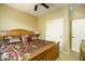 Bedroom featuring a ceiling fan and large window for optimal natural lighting and attached closet at 2662 S Springwood S Blvd # 338, Mesa, AZ 85209