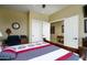 Cozy bedroom featuring a comfortable bed, neutral walls, and multiple doorways that enhance the spacious feel of the room at 2662 S Springwood S Blvd # 338, Mesa, AZ 85209