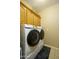 The laundry room has a large, modern Samsung washing machine and dryer with wooden cabinetry for storage at 2662 S Springwood S Blvd # 338, Mesa, AZ 85209