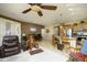 Bright living room featuring tile flooring, a kitchen island with barstool seating, and separate dining area with a brown table at 2662 S Springwood S Blvd # 338, Mesa, AZ 85209
