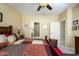Comfortable primary bedroom featuring a ceiling fan, attached primary bath, neutral paint, and carpet at 2662 S Springwood S Blvd # 338, Mesa, AZ 85209