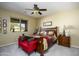 Comfortable primary bedroom featuring a ceiling fan, large window, neutral paint, and carpet at 2662 S Springwood S Blvd # 338, Mesa, AZ 85209