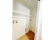 A white laundry room equipped with washer hookups, tiled floor and shelving at 2737 W Alice Ave, Phoenix, AZ 85051